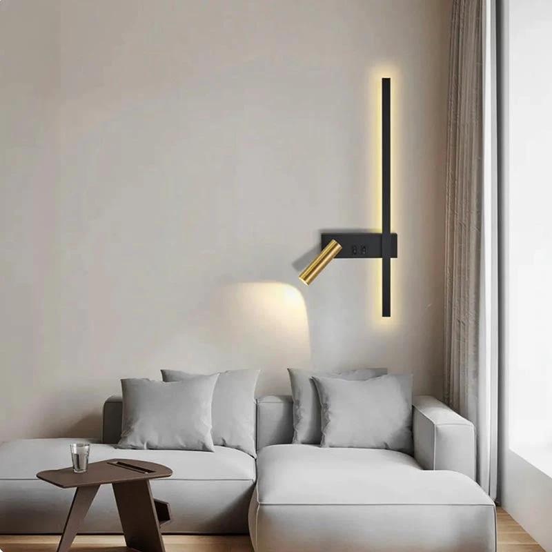 Swivel LED Wall Light with vertical black strip and brass adjustable head on living room wall beside sofa